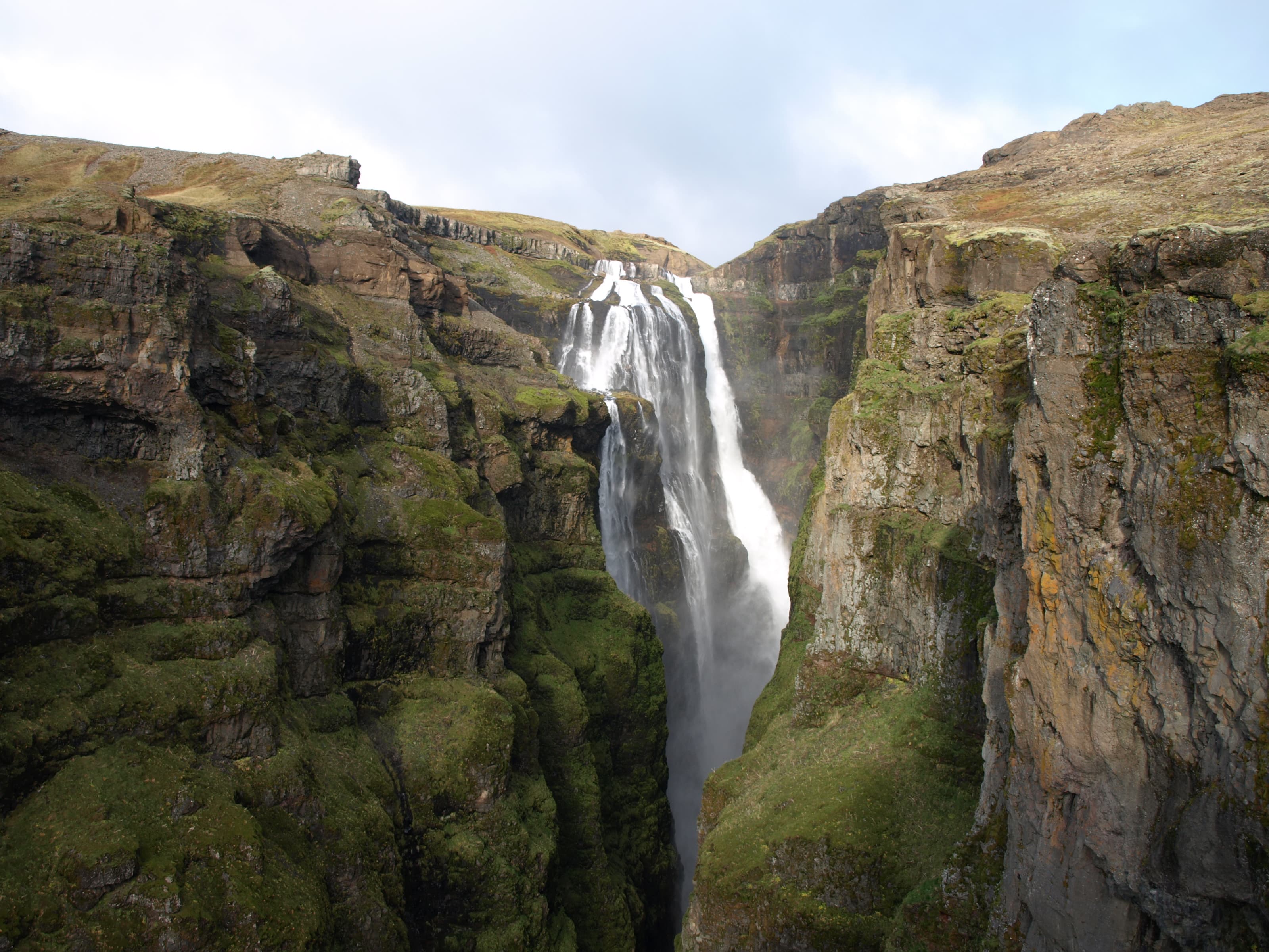 Glymur waterfall dropping into a deep mossy canyon at the head of Hvalfjörður