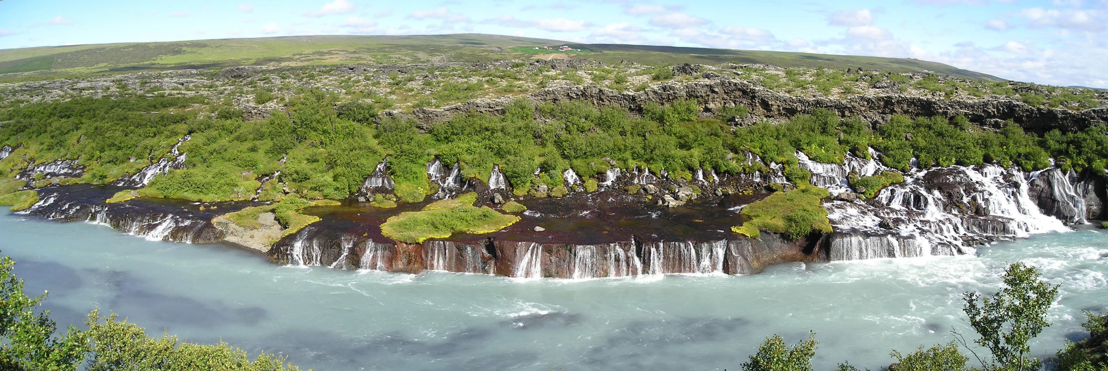 Hraunfossar — water seeping out of a lava field into the turquoise Hvítá river