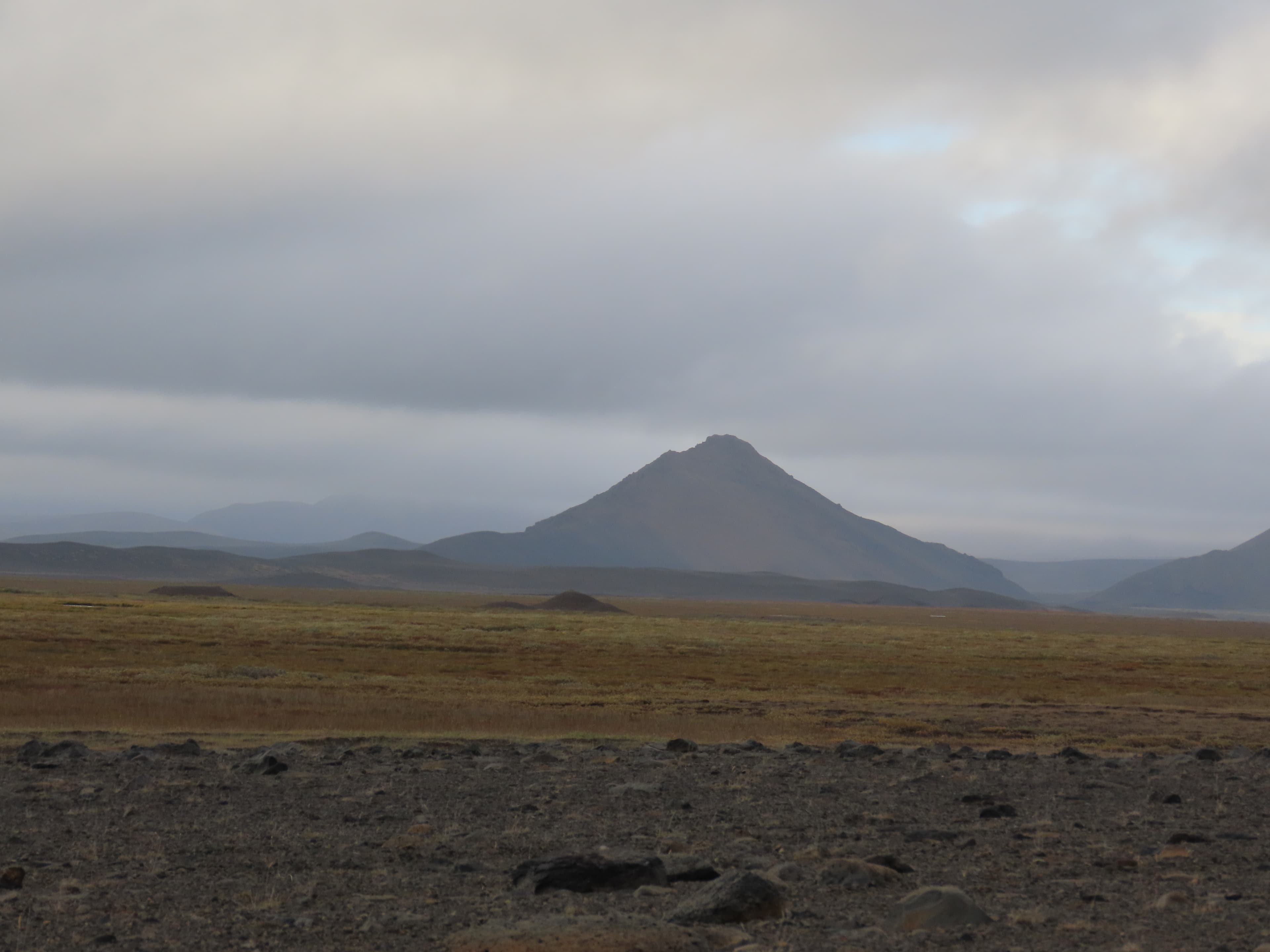 An exposed sand-and-gravel road in Iceland, the kind of surface that produces blowing sand in high wind