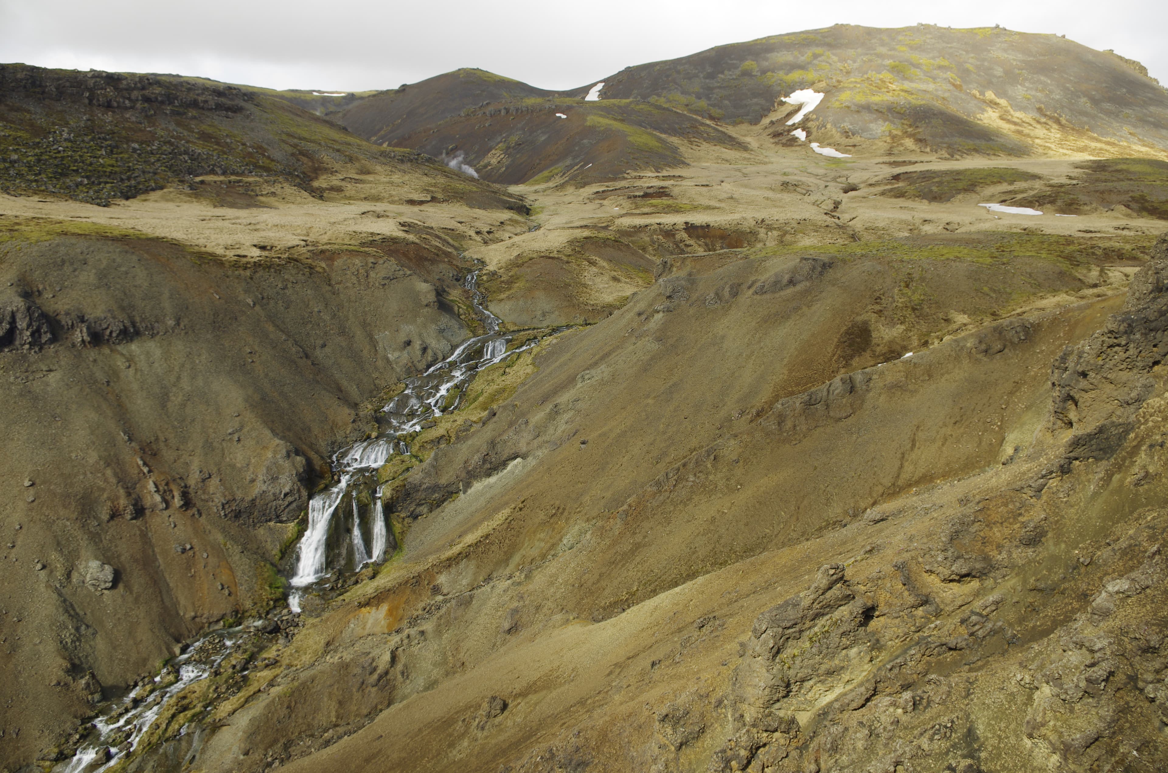 The warm bathing river in Reykjadalur, Iceland, steam over the water