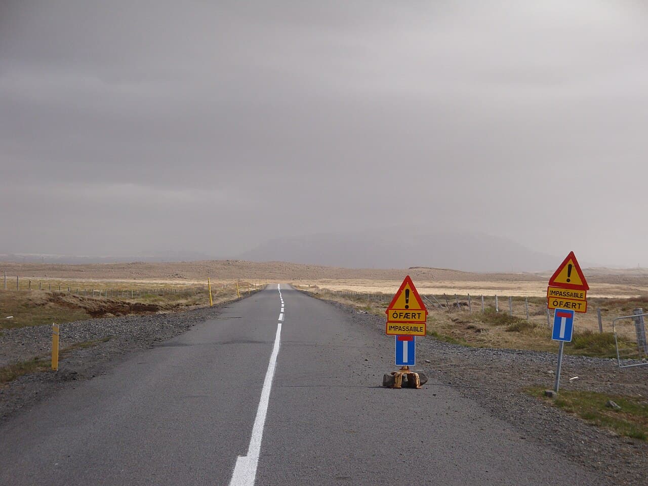 An F-road in Iceland gated and closed for winter, with a barrier across the track
