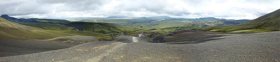 An F-road gravel track winding through the Icelandic Highlands under open sky