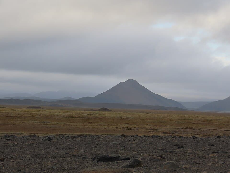 An exposed sand-and-gravel road in Iceland, the kind of surface that produces blowing sand in high wind