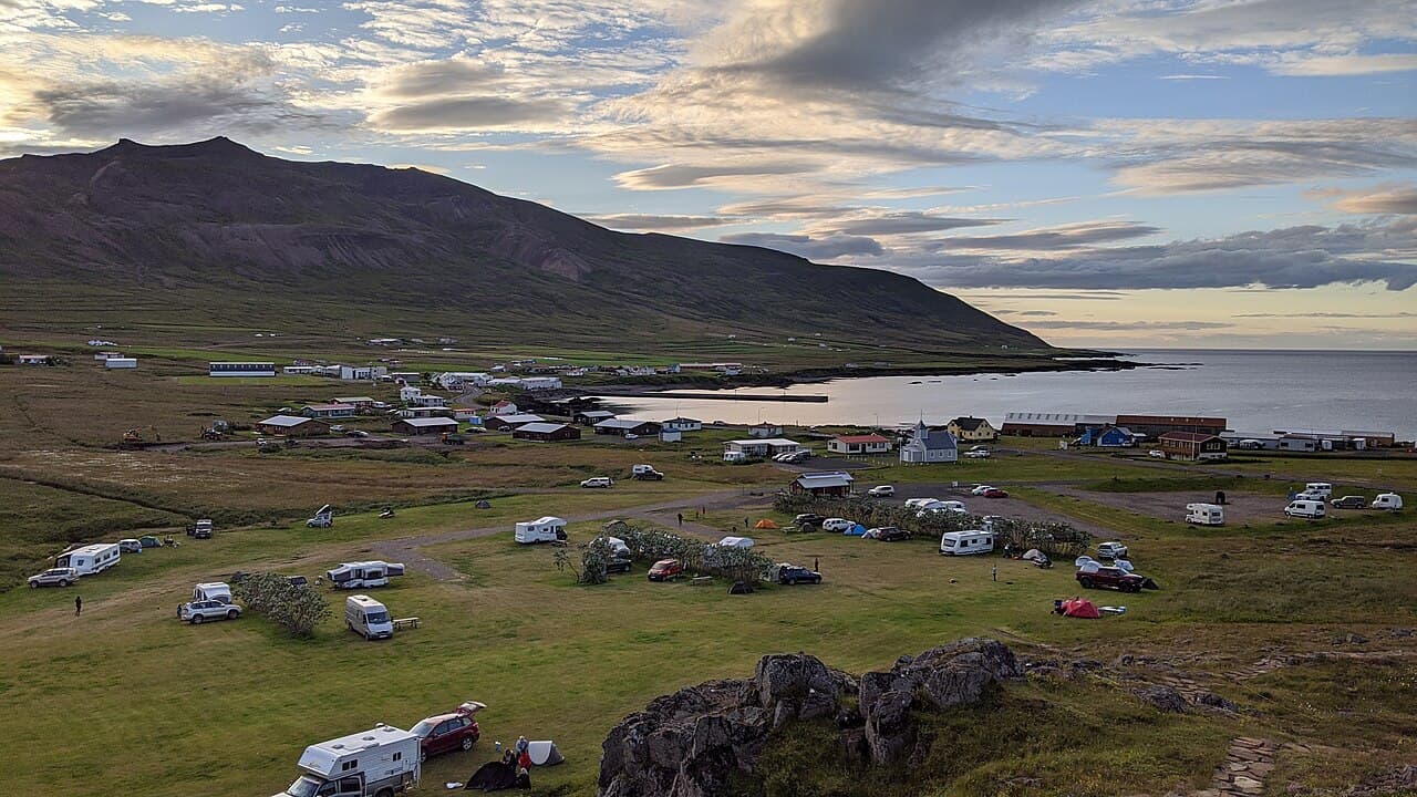 An Icelandic coastal village under long, low evening light in the shoulder season