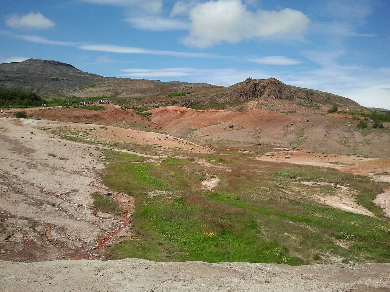 Green summer landscape in southern Iceland near Geysir, under broken cloud