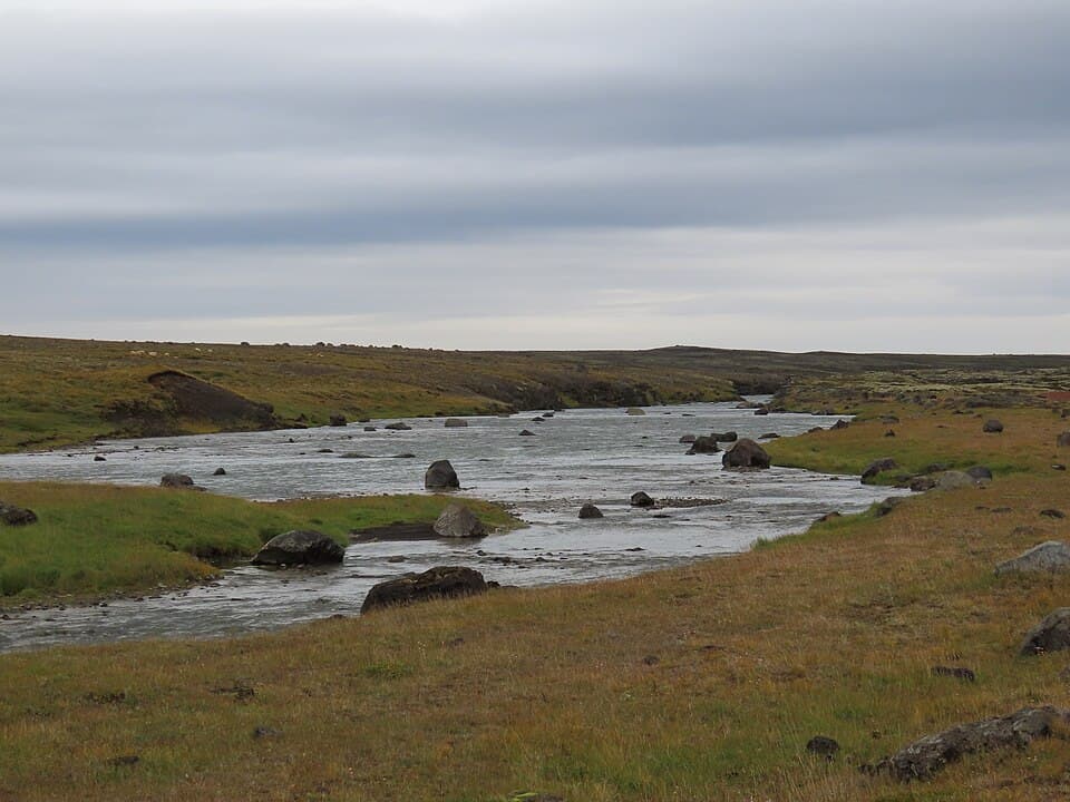 The Norðlingafljót river running across the Arnarvatnsvegur highland track, with boulders breaking the surface